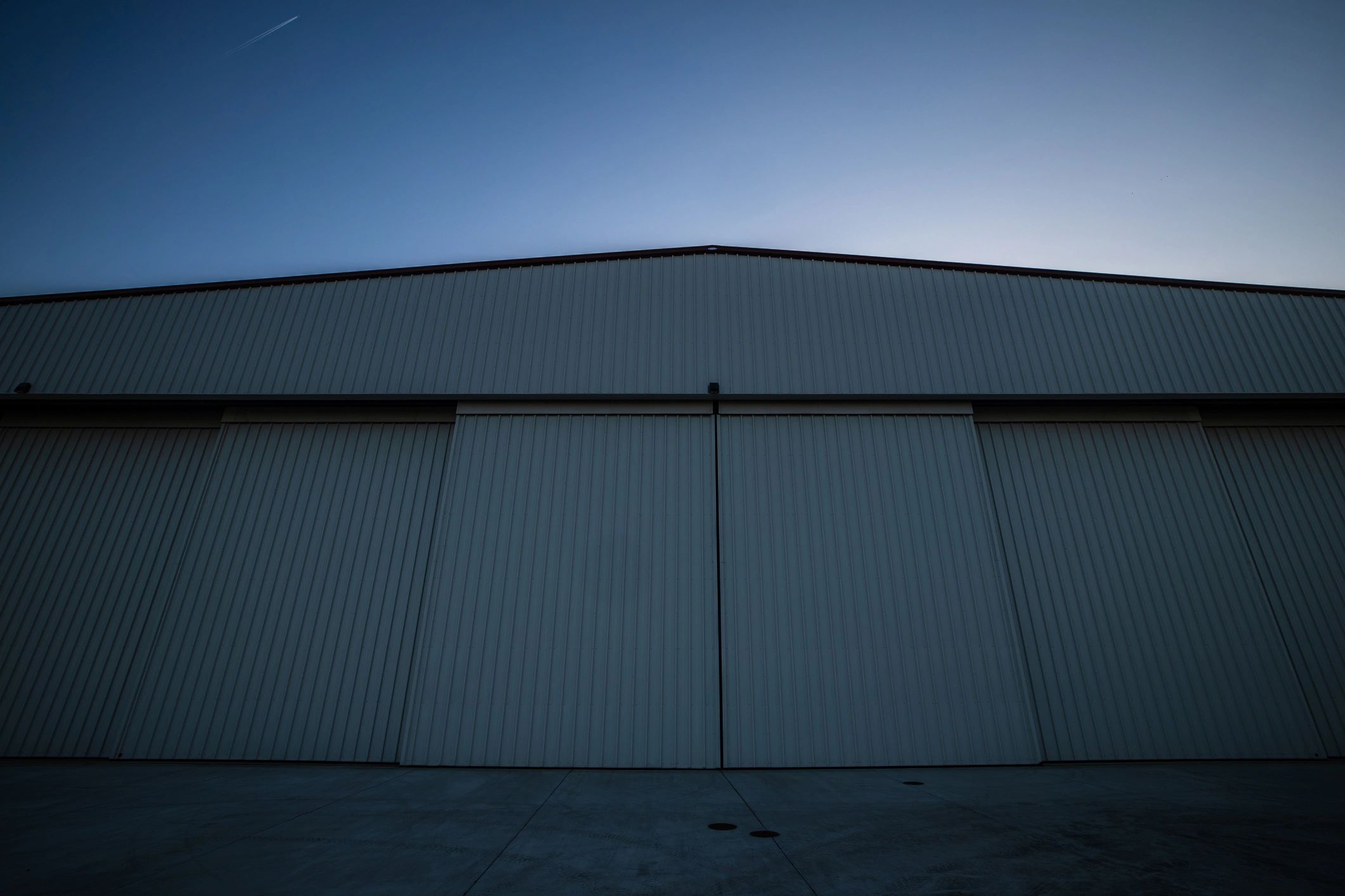 Aircraft hangar at sunset representing aviation operations
