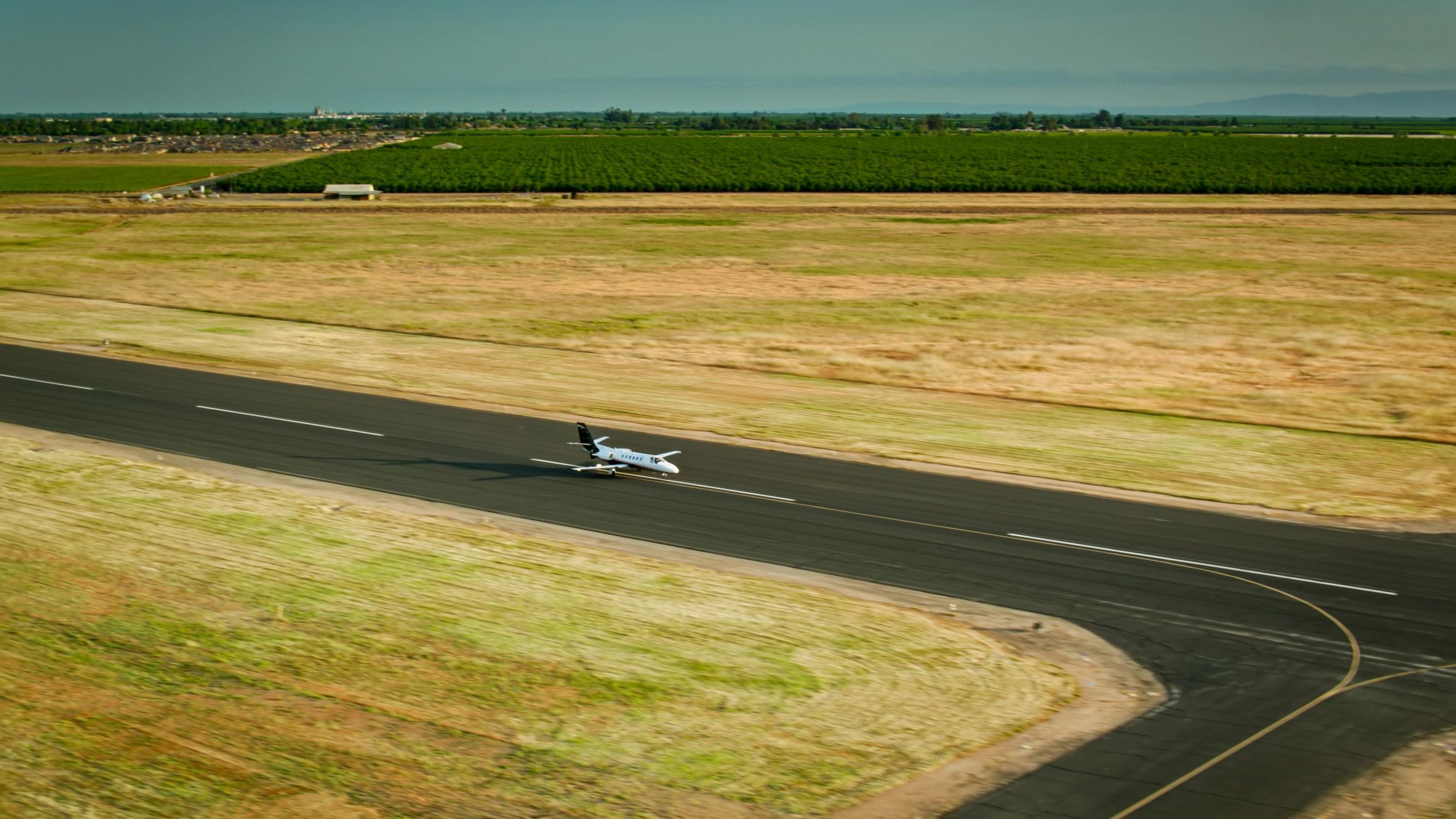 Private business jet taxiing on a runway at a general aviation airport